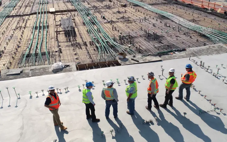 Construction crew on large work site, multiple city blocks