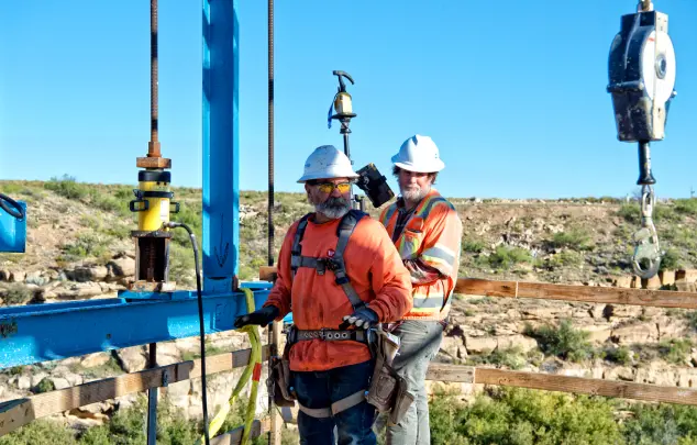 2 crew members high with crane