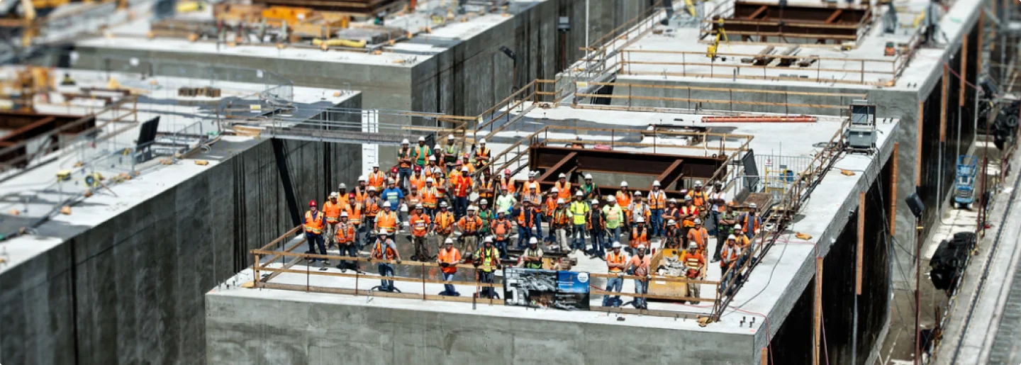 Builld Safer Together - Large construction crew on top of building