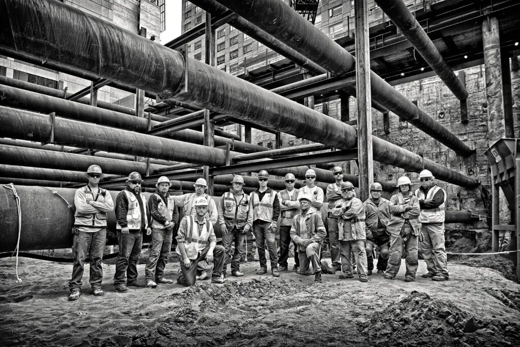 Construction workers by installed pipes