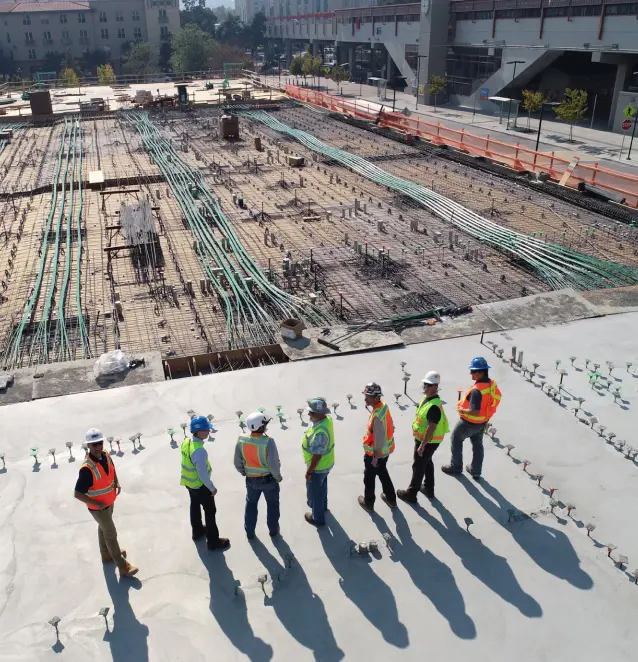 Construction crew on large work site, multiple city blocks
