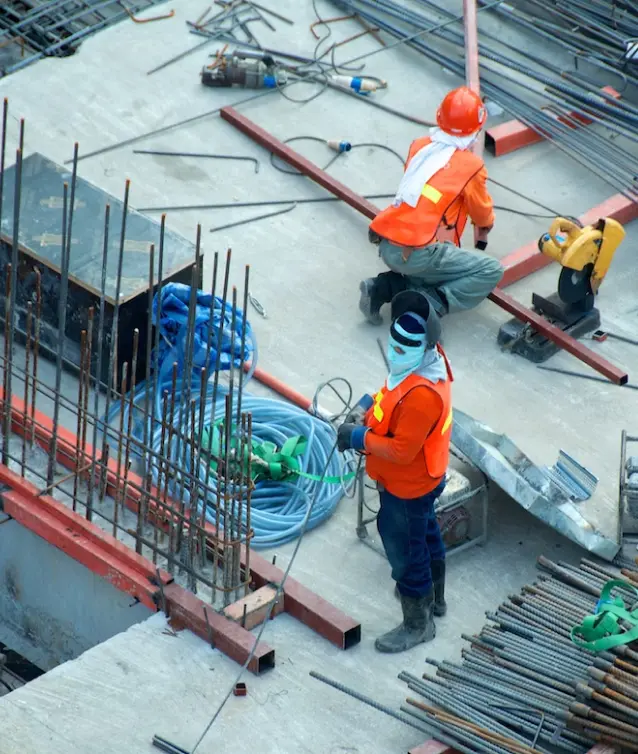 Construction crew on rooftop, rebar