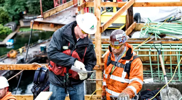2 construction workers wearing heavy gear