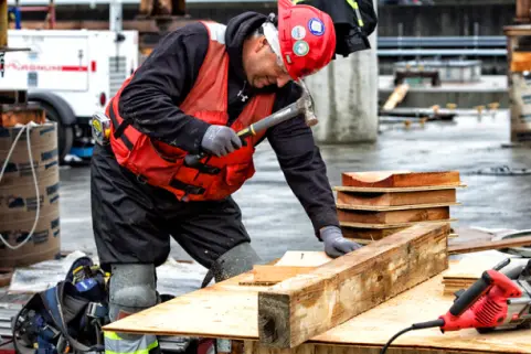 Crew member on site hammering